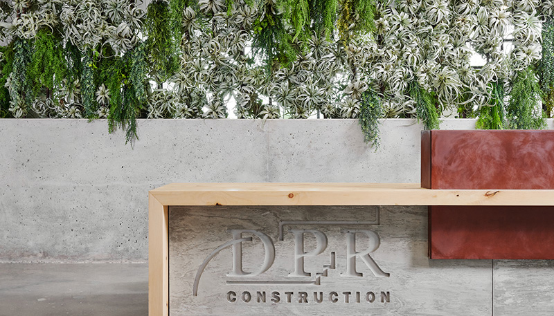 Living wall behind a DPR sign in the Austin office.