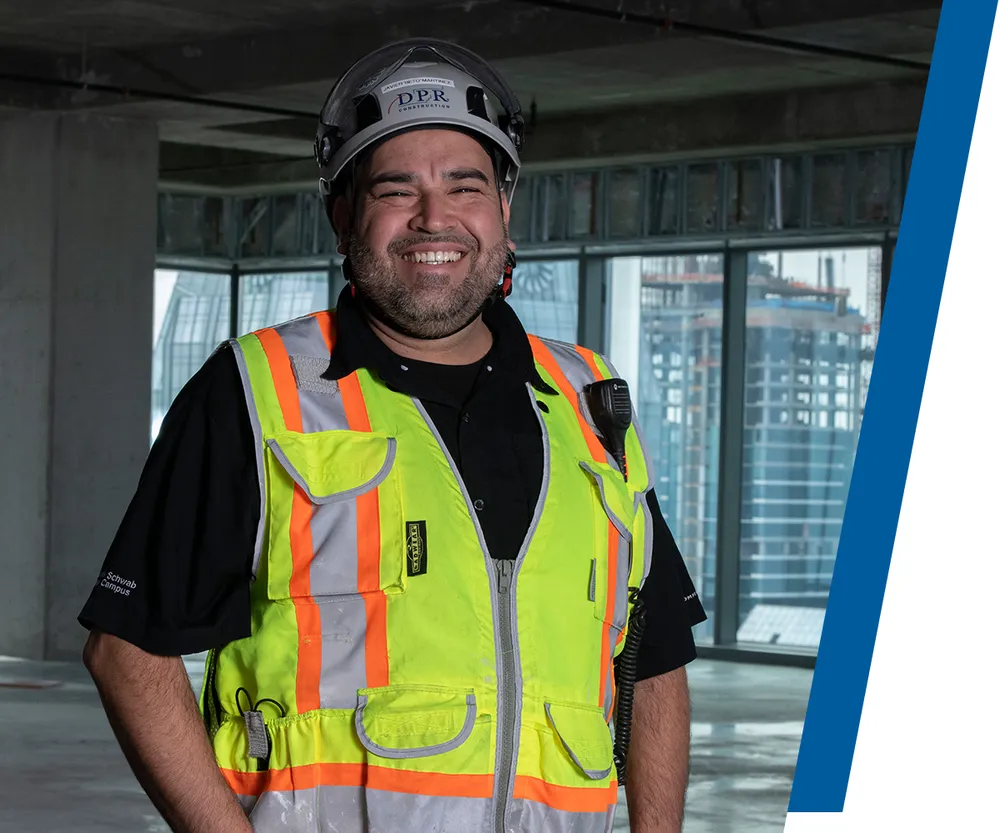 skilled craft professional smiling in full ppe on a jobsite